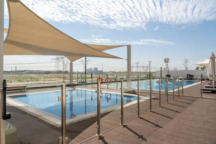 Glass pool safety fence beside a pool